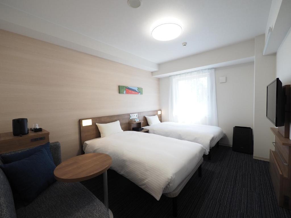 Postel nebo postele na pokoji v ubytování Tabino Hotel Kashima