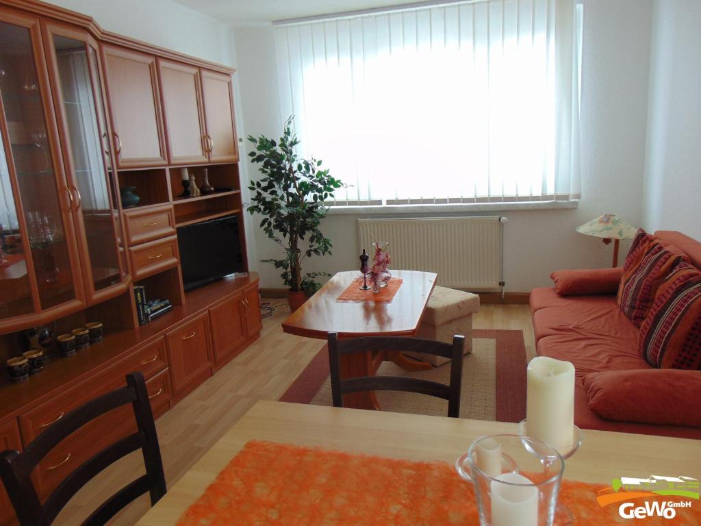 a living room with a couch and a table at Ferienwohnung August 30 in Gelenau