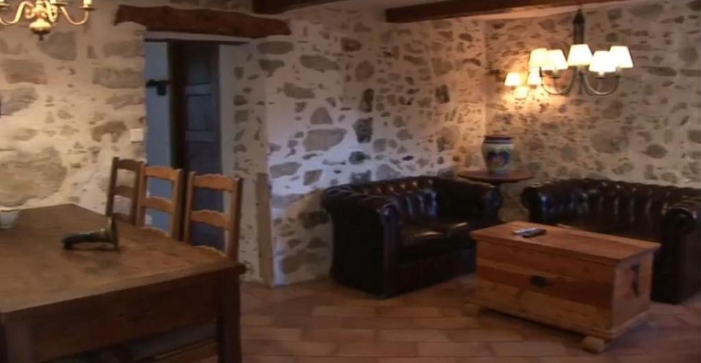 a living room with leather chairs and a table at Romantic-Louveteaux-en-Provence**** in Saint-Pierre