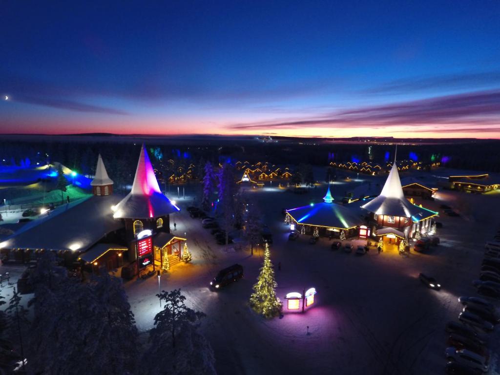 an aerial view of a christmas market at night at Santa Claus Holiday Village in Rovaniemi
