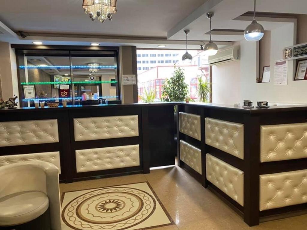 a restaurant with a bar with chairs and a counter at Hotel Han Krum in Targovishte