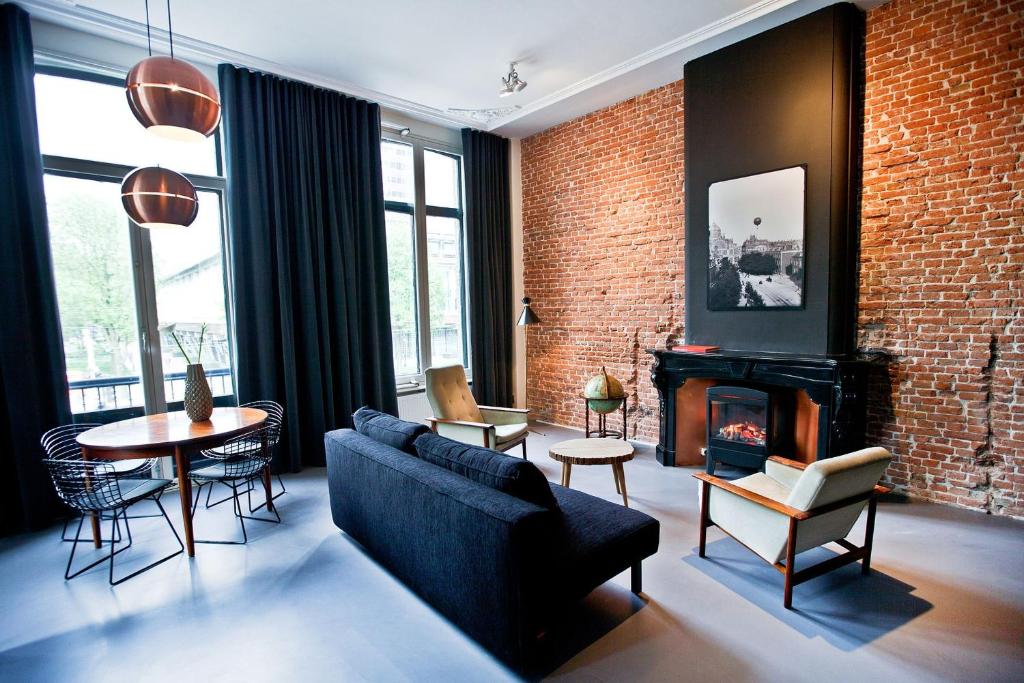 a living room with a couch and a fireplace at V Lofts in Amsterdam