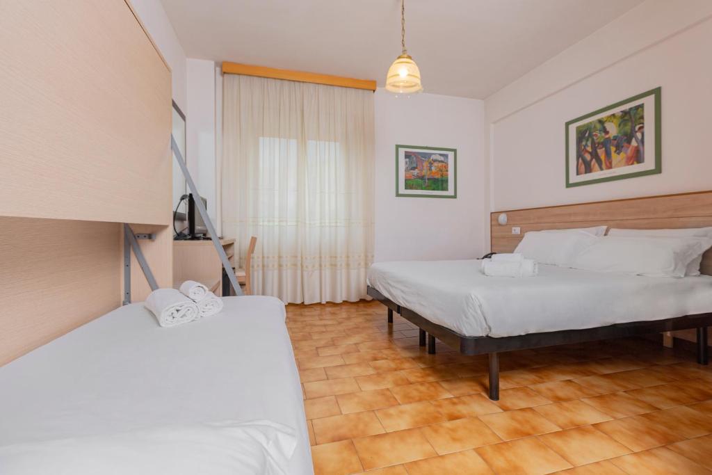 Postel nebo postele na pokoji v ubytování Catignano Hotel
