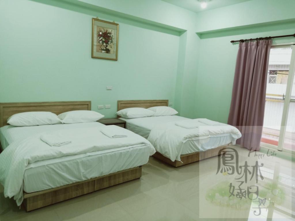 a bedroom with two beds and a window at 鳳林好日子 in Fenglin