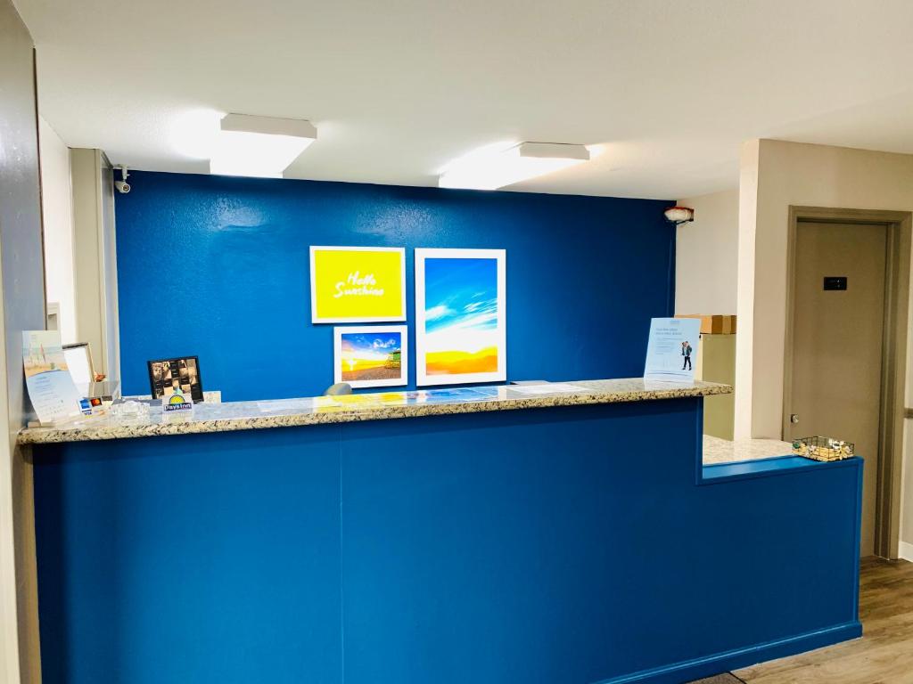 a blue wall with a counter in a room at Days Inn by Wyndham Ardmore in Ardmore