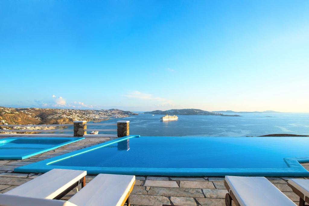 a pool with a view of the ocean at Aeri Villas & Apartments in Tourlos