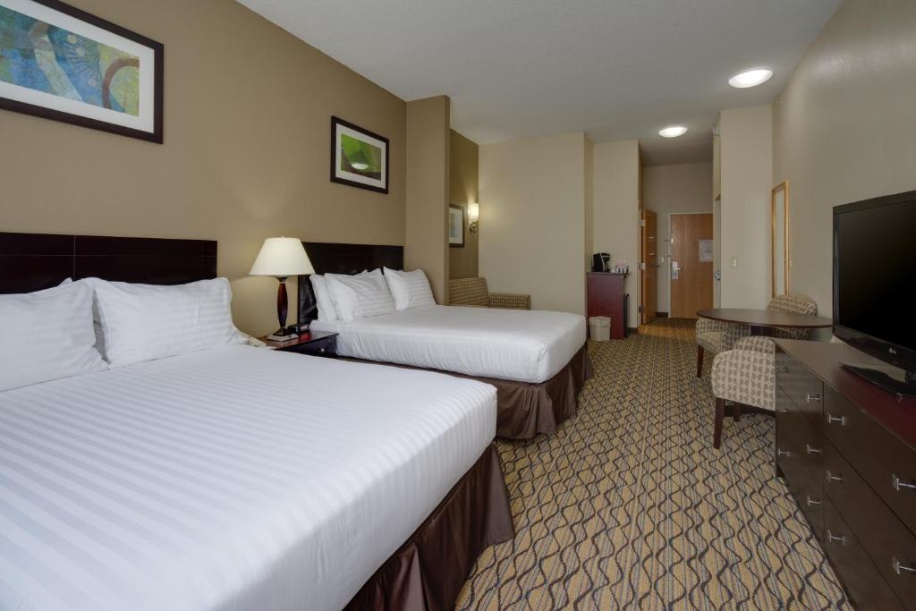 a hotel room with two beds and a flat screen tv at Holiday Inn Express Charles Town, an IHG Hotel in Shenandoah Junction