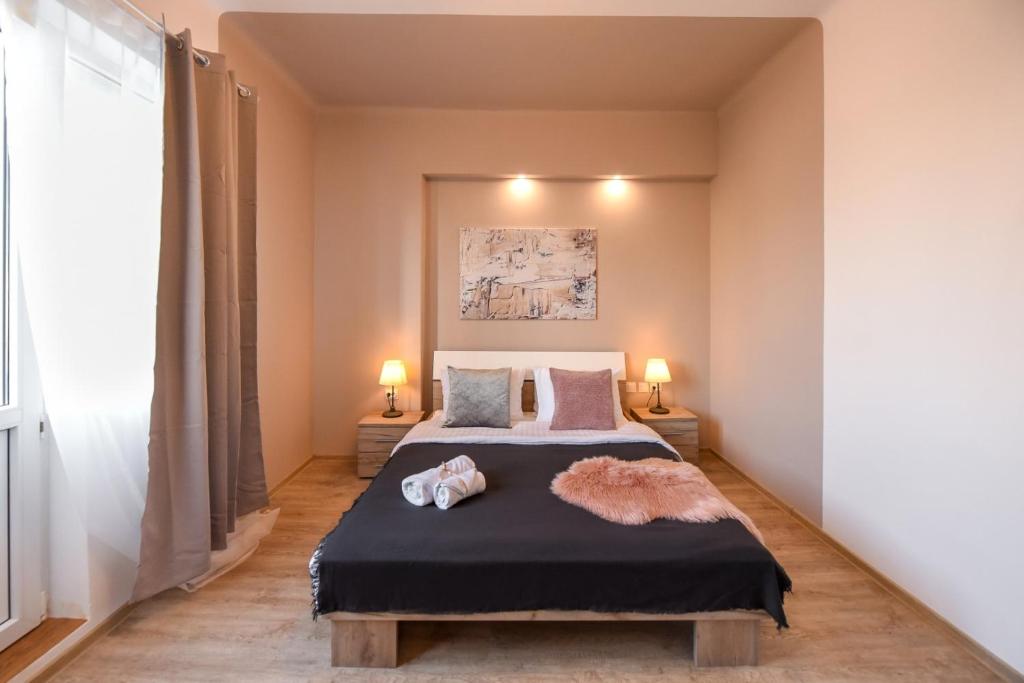 Ένα ή περισσότερα κρεβάτια σε δωμάτιο στο PASTEL HUES - Homey Central Apartment near Armeneasca