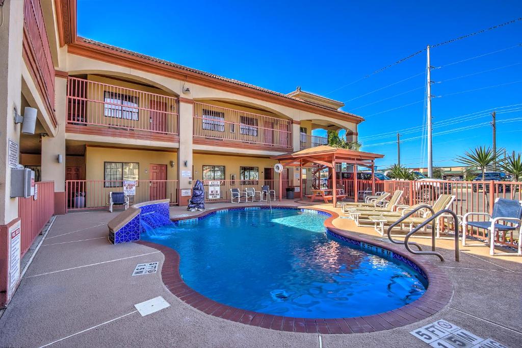 a swimming pool in front of a building at Casa Rosa Inn in Port Isabel