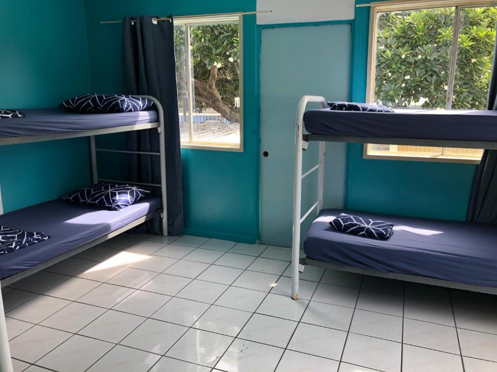 A bed or beds in a room at Darwin Hostel