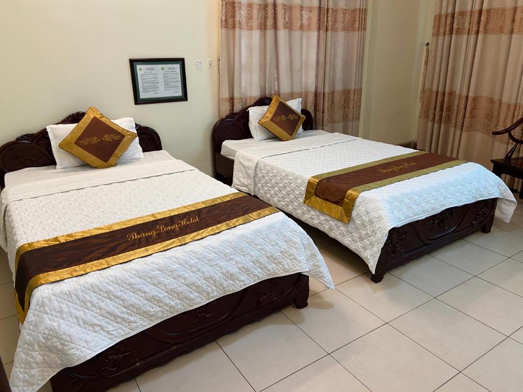 Postel nebo postele na pokoji v ubytování Thang Long Hotel