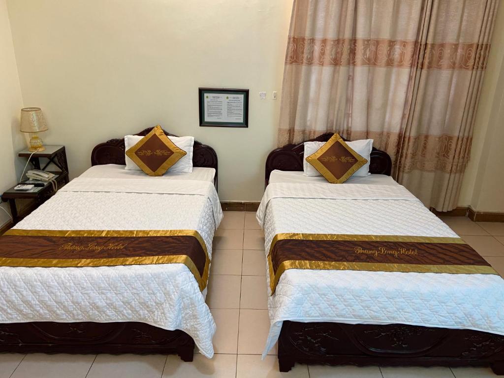 Postel nebo postele na pokoji v ubytování Thang Long Hotel