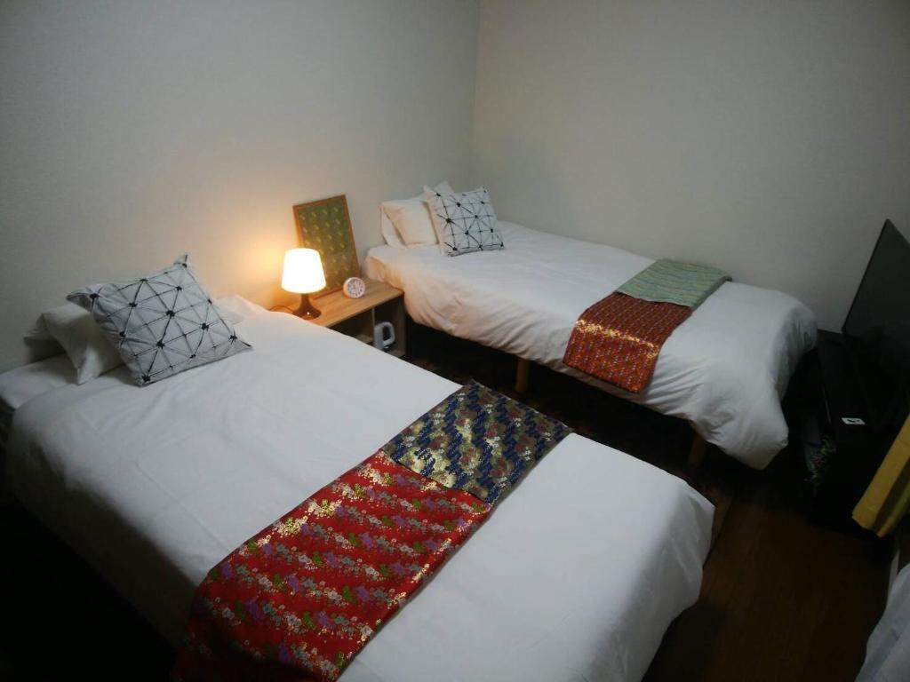 En eller flere senger på et rom på KYOTO SHIMA