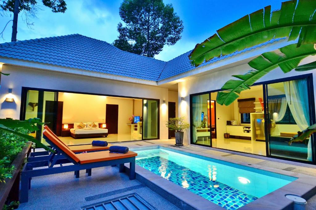 a villa with a swimming pool and a house at Chaweng Noi Pool Villa in Chaweng Noi Beach