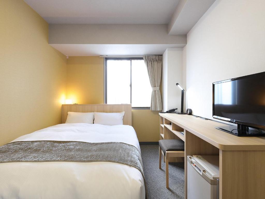 Postel nebo postele na pokoji v ubytování Matsue Urban Hotel