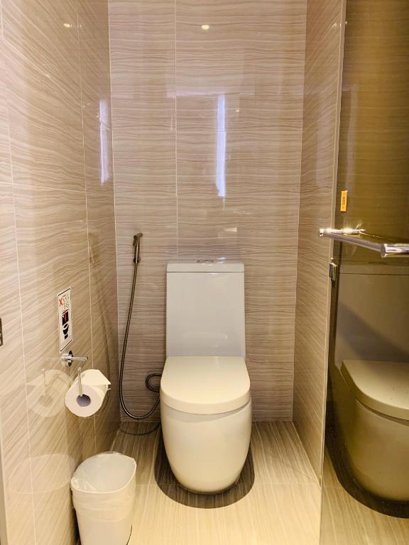 a bathroom with a white toilet and a sink at City Suites - Kaohsiung Chenai in Kaohsiung