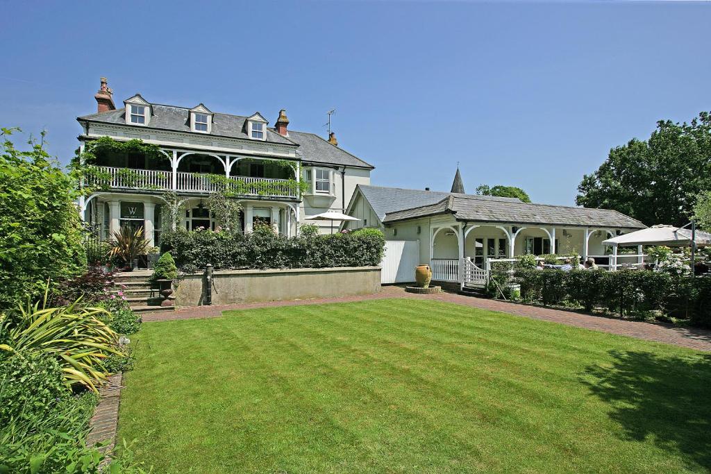 a large house with a lawn in front of it at Wingrove House in Alfriston