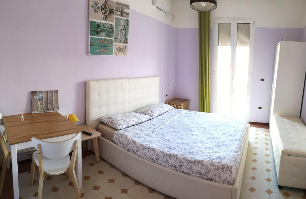 a bedroom with a bed and a desk and a chair at New Life in Mestre