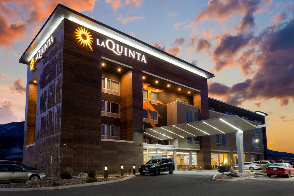 a hotel with a car parked in a parking lot at La Quinta by Wyndham Cedar City in Cedar City
