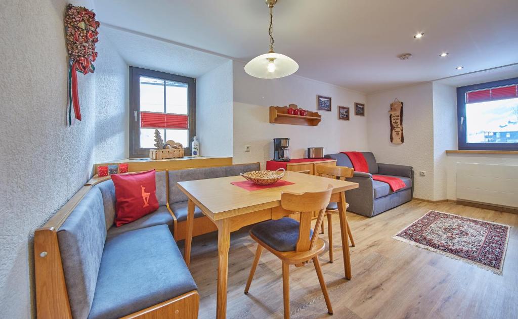 a living room with a couch and a table at Appartement zum Turm Top 4 in Saalbach-Hinterglemm