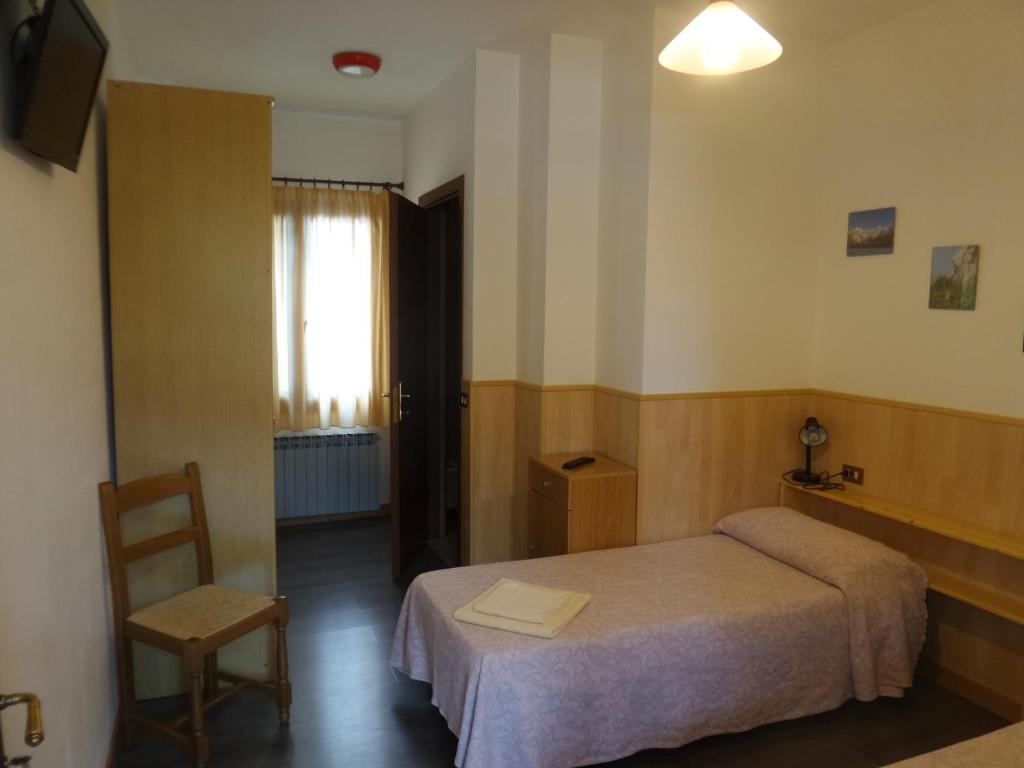 Łóżko lub łóżka w pokoju w obiekcie Al Fogolar