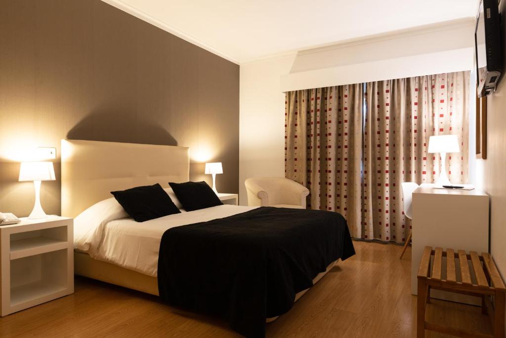 Postel nebo postele na pokoji v ubytování Hotel Durao