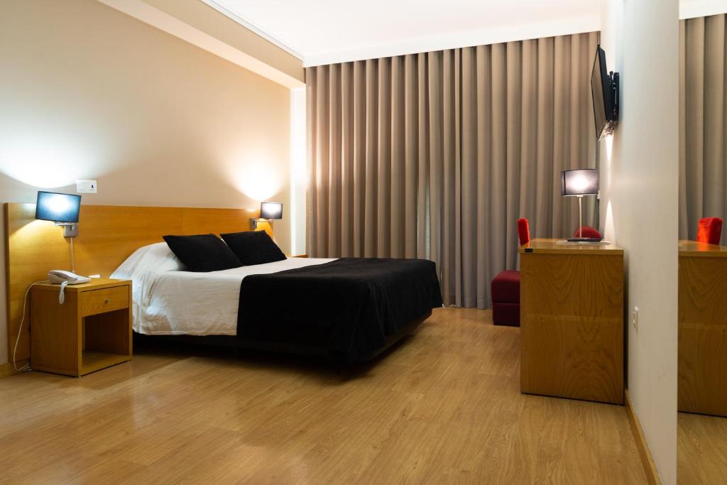 Postel nebo postele na pokoji v ubytování Hotel Durao