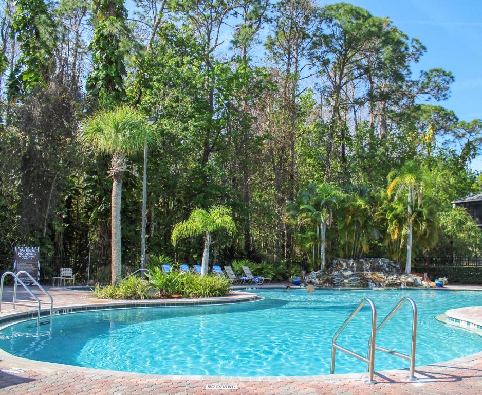 a large swimming pool with trees in the background at Parkway International Resort in Orlando