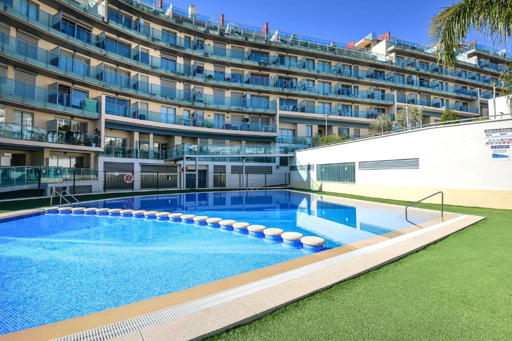 a large apartment building with a large swimming pool at Homeincalpe Borumbot in Calpe