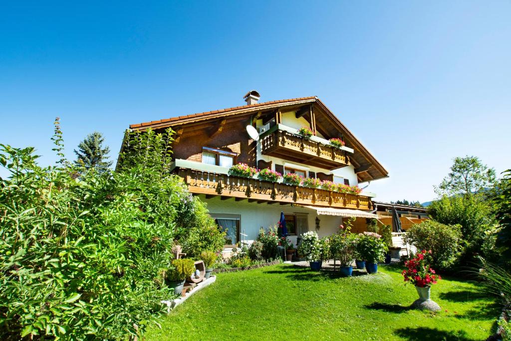 a house with a garden in front of it at Gästehaus Christa in Obermaiselstein