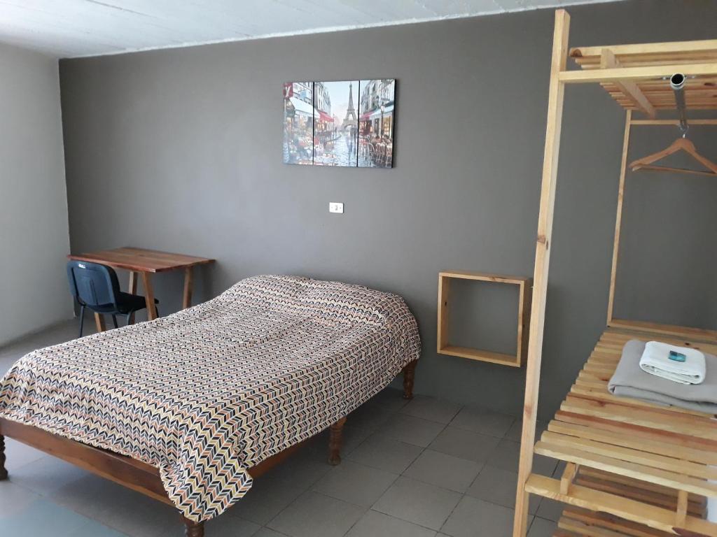 een slaapkamer met een bed, een spiegel en een ladder bij Posada Loreto Xalapa in Xalapa