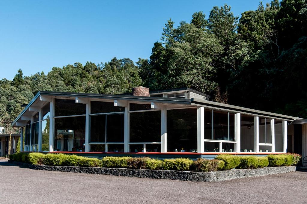 a large building with windows and trees in the background at Silver Hills Motel in Queenstown