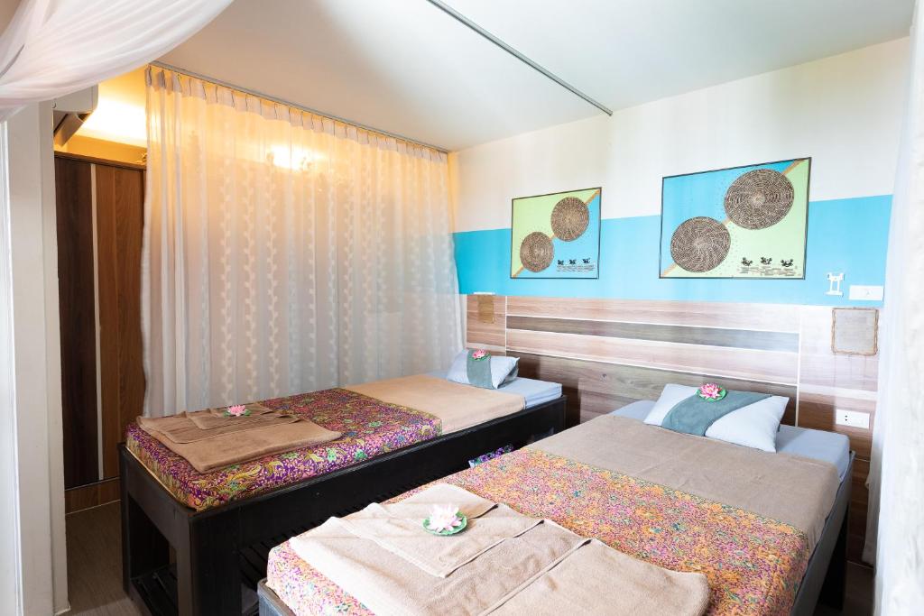 Postel nebo postele na pokoji v ubytování Palm Coco Mantra