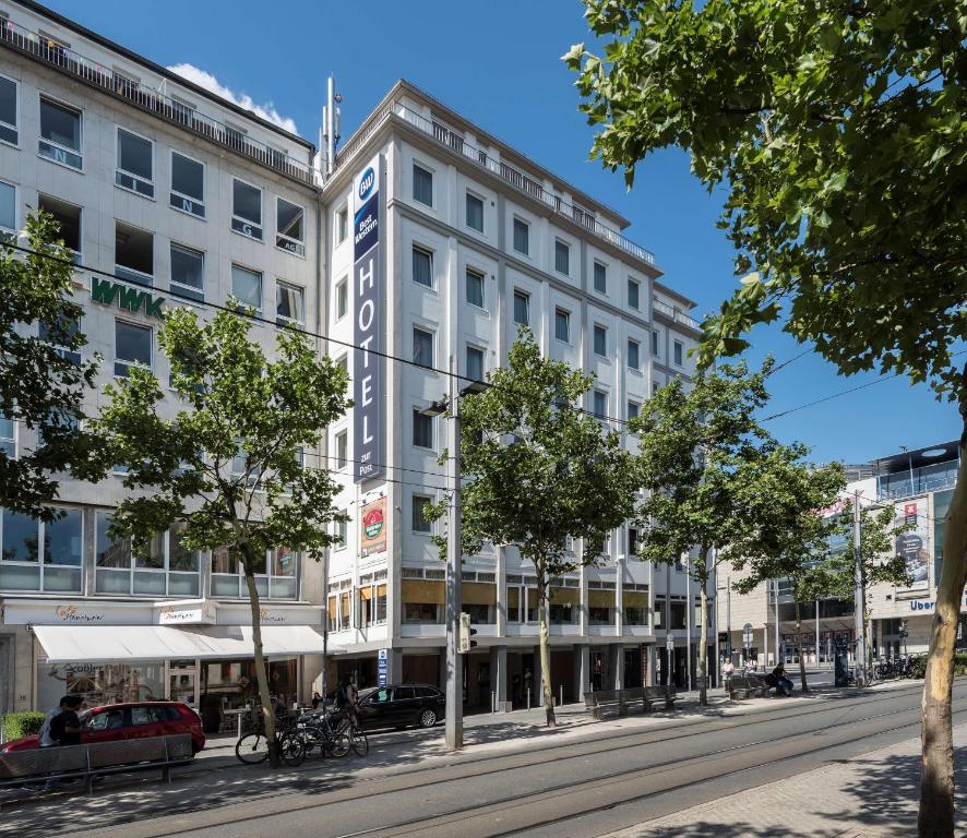 ein großes weißes Gebäude in einer Stadtstraße in der Unterkunft Best Western Hotel zur Post in Bremen