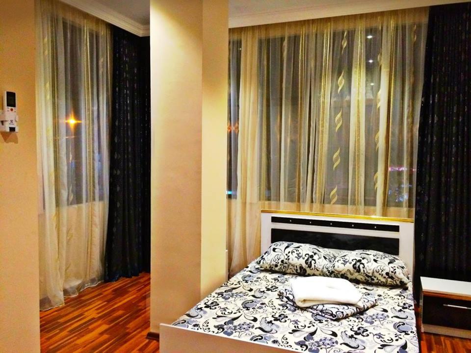 a bedroom with a bed and a window at Golden House in Batumi