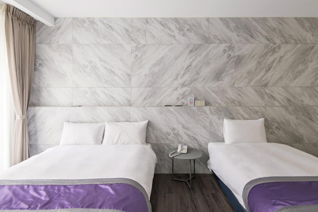 Postel nebo postele na pokoji v ubytování Hotel Hesper HSR Taichung