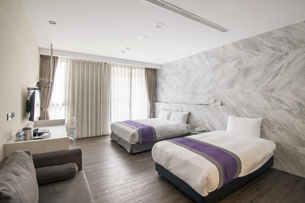 Postel nebo postele na pokoji v ubytování Hotel Hesper HSR Taichung