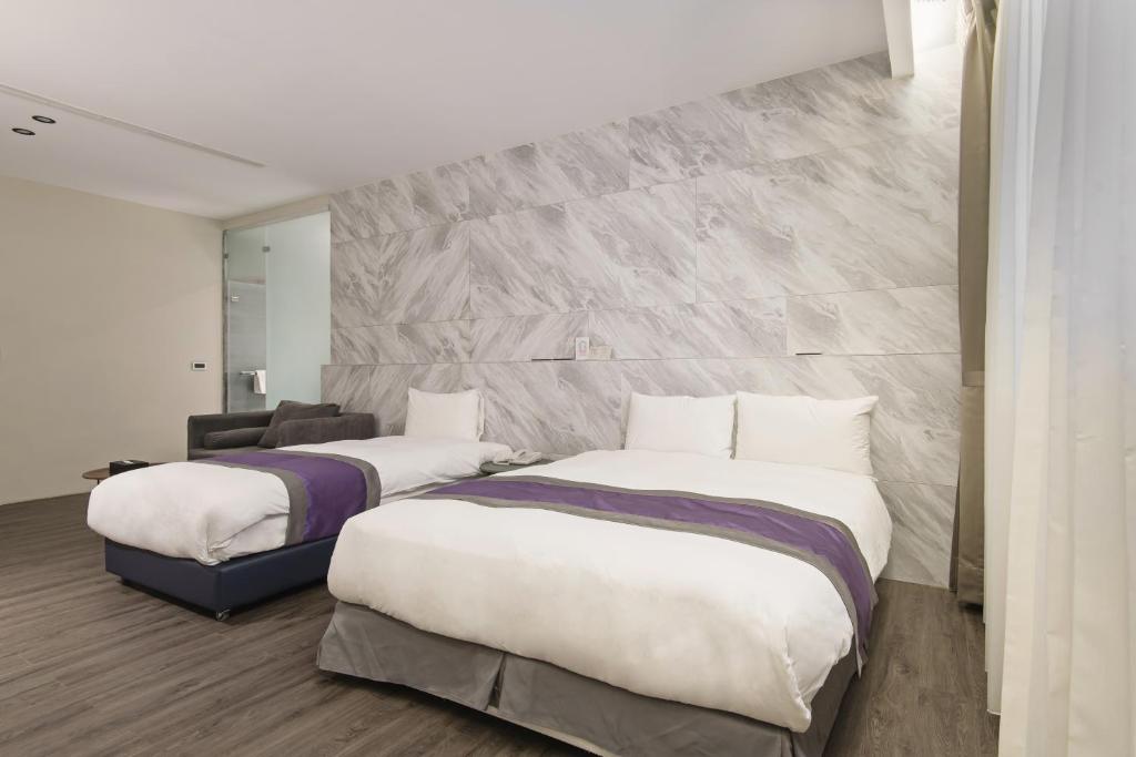 Postel nebo postele na pokoji v ubytování Hotel Hesper HSR Taichung