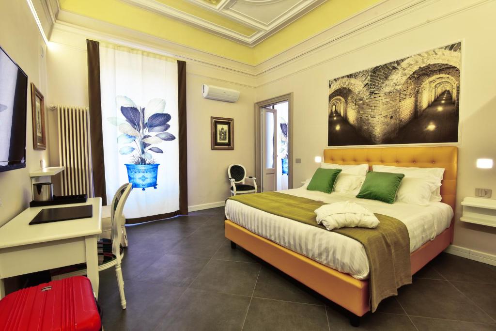 Postel nebo postele na pokoji v ubytování ANFITEATRO LE SUITES