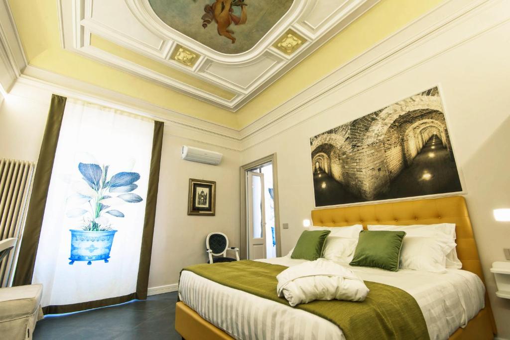 Postel nebo postele na pokoji v ubytování ANFITEATRO LE SUITES