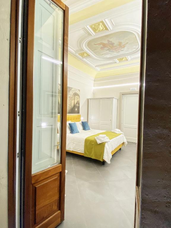Postel nebo postele na pokoji v ubytování ANFITEATRO LE SUITES