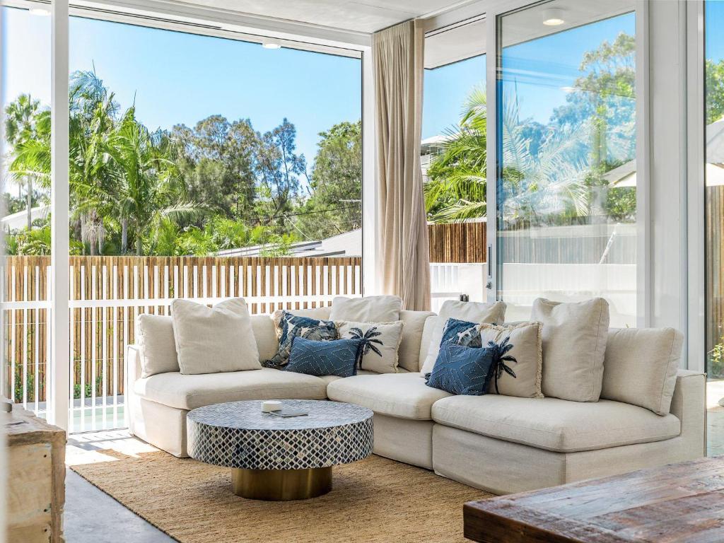 a living room with a couch and a table at Audrey in Byron Bay