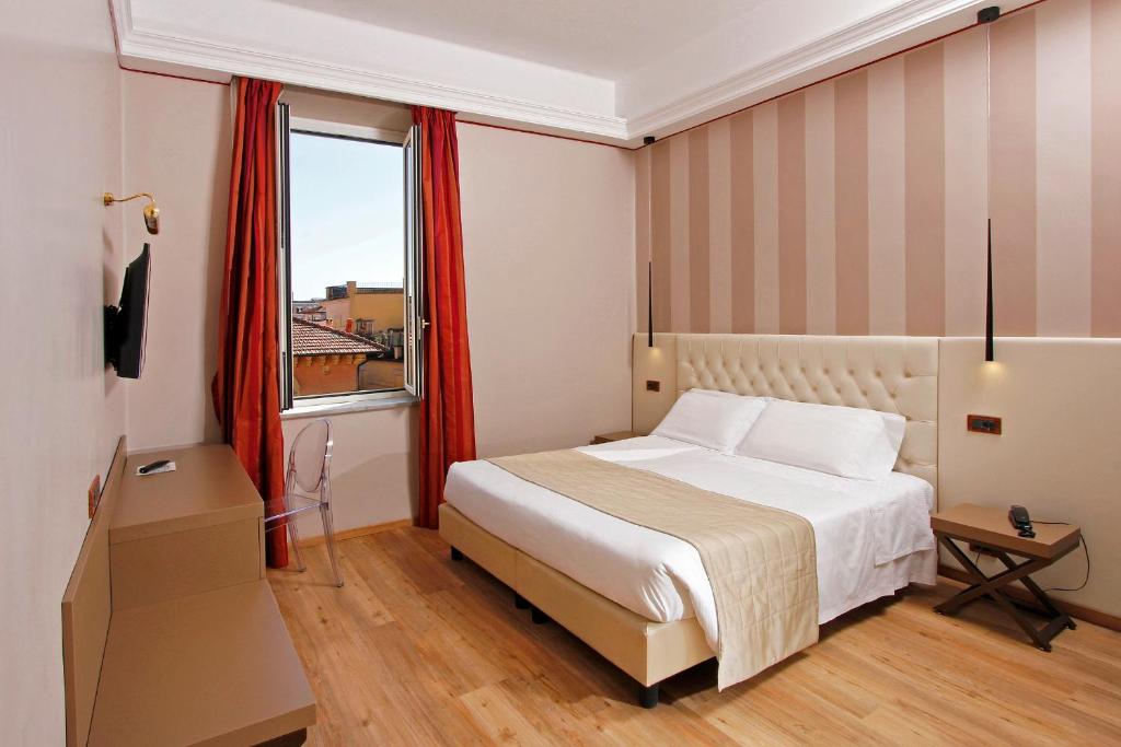 Postel nebo postele na pokoji v ubytování Hotel Arcangelo
