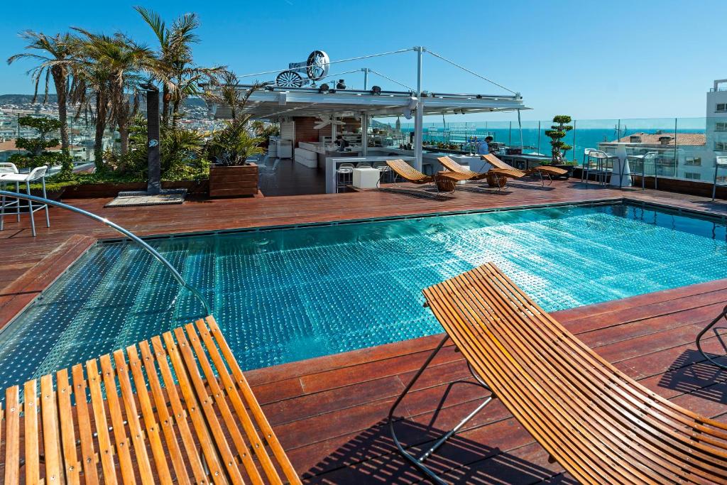 a swimming pool on top of a building at Hotel MiM Sitges & Spa in Sitges