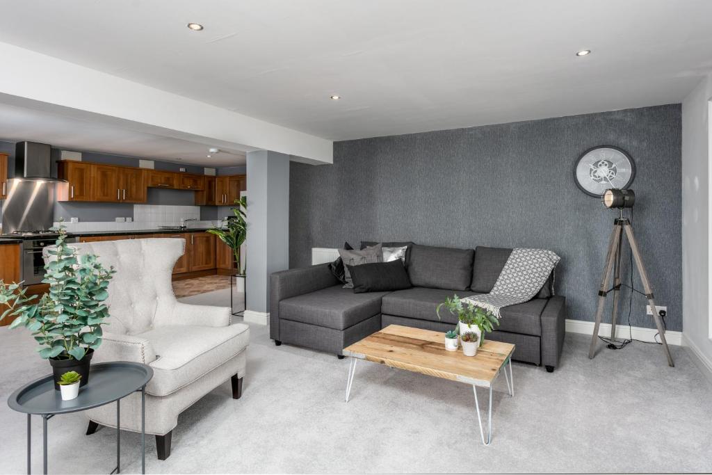 a living room with a couch and a table at Granary Suite No22 - Donnini Apartments in Ayr