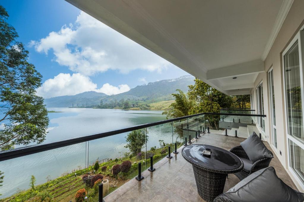 a house with a balcony with a view of a lake at Villa Serenity in Hatton