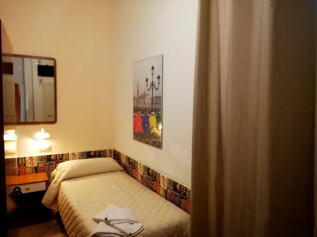 Postel nebo postele na pokoji v ubytování Hotel Galles Rimini