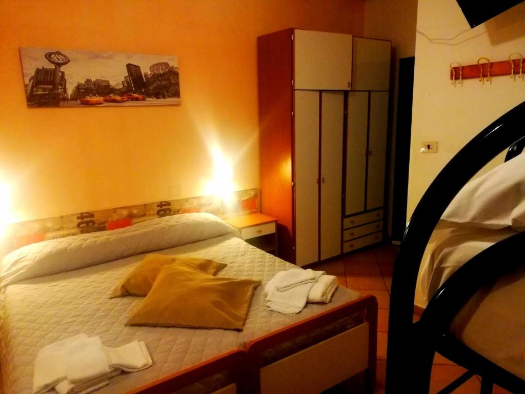 Postel nebo postele na pokoji v ubytování Hotel Galles Rimini