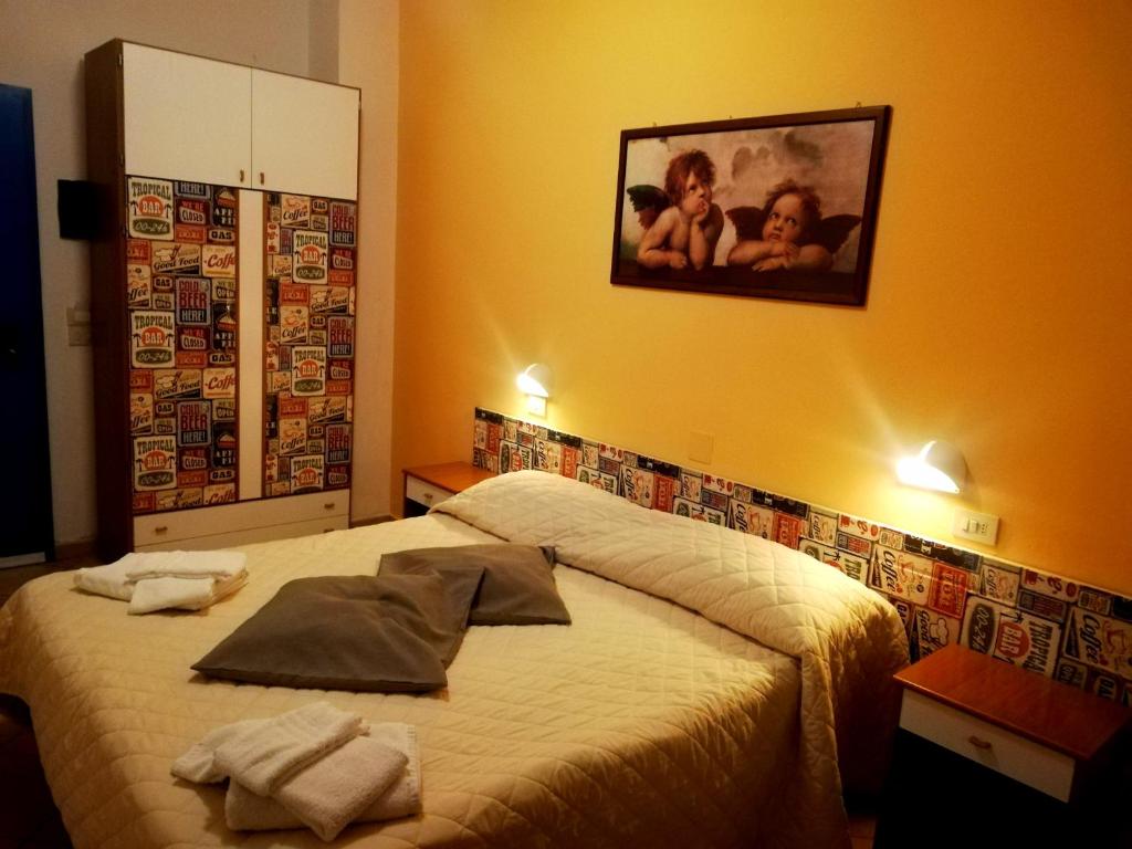 Postel nebo postele na pokoji v ubytování Hotel Galles Rimini