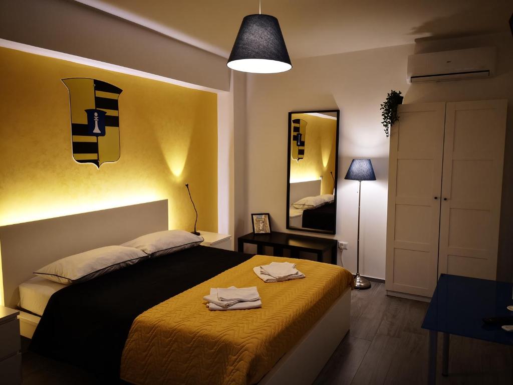 a bedroom with a bed with two towels on it at La Disfida Di Barletta in Barletta